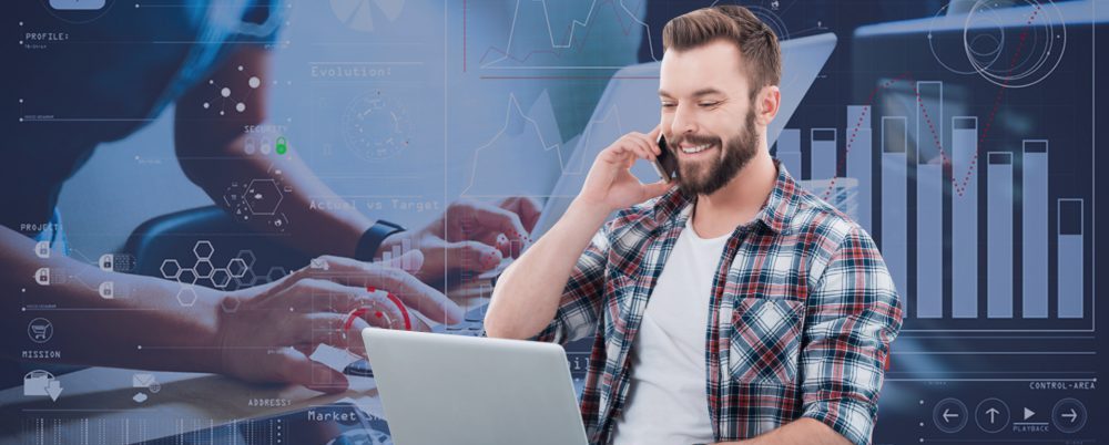 man working on laptop with phone on analytics Dashboard