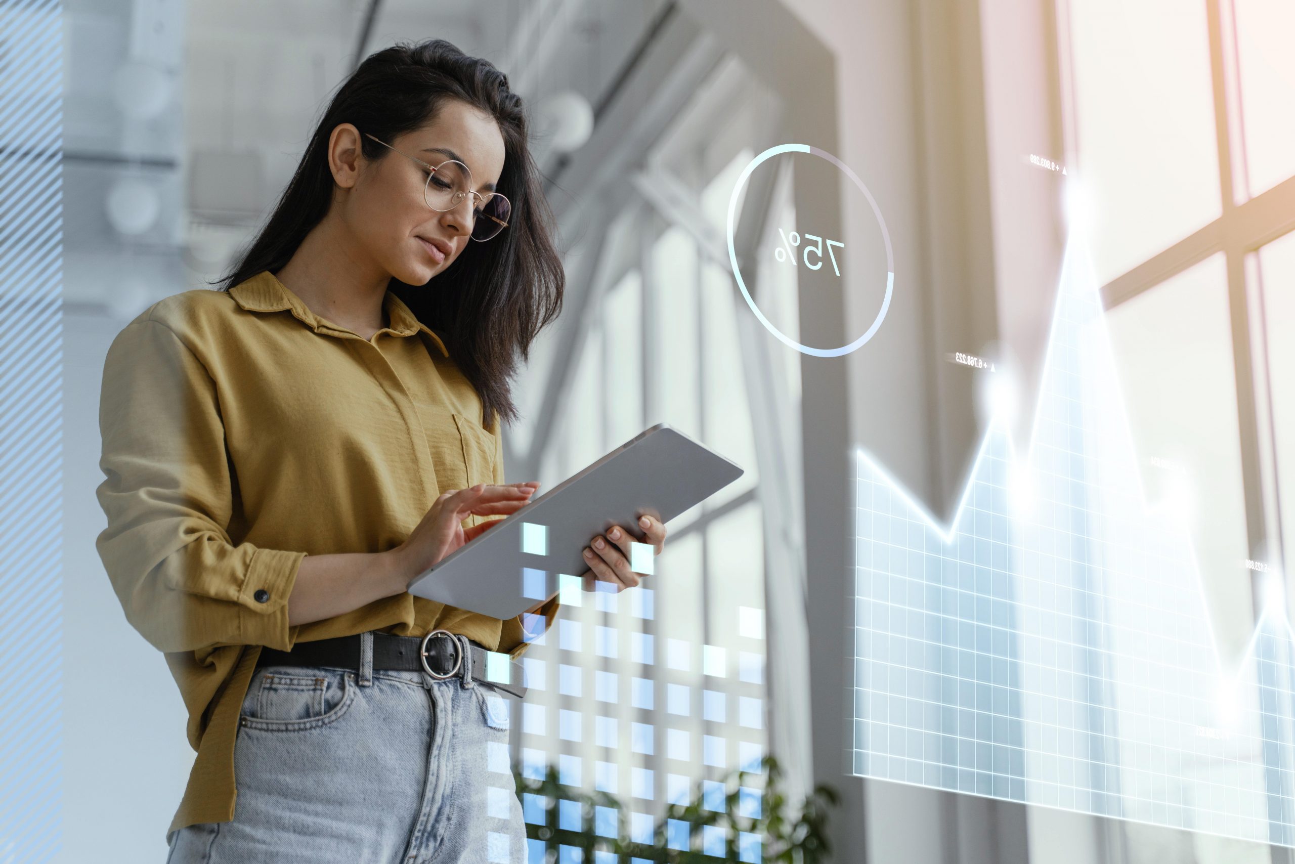 Woman holding tablet analyzing data graphs