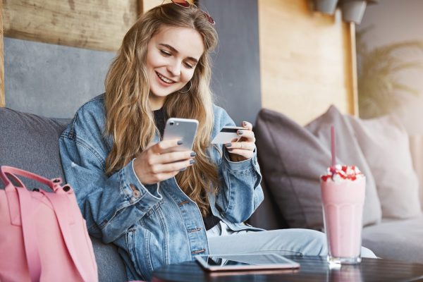 Pretty Girl paying on her phone via credit card